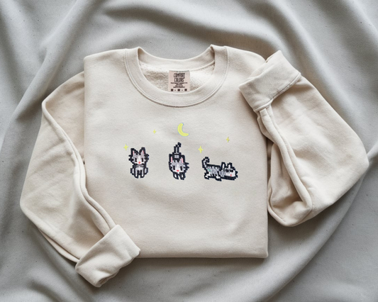 Close up of Stardew Valley cat pixel art embroidery White Comfort Colors 1566