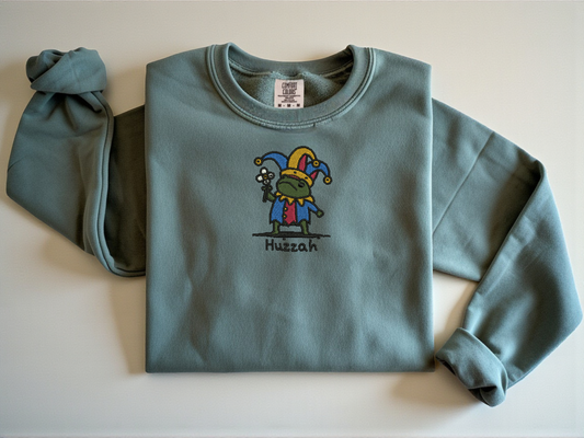 Blue Jean vintage navy sweatshirt featuring embroidered Jester Frog shouting Huzzah. Medieval fantasy aesthetic streetwear by Peachnook.