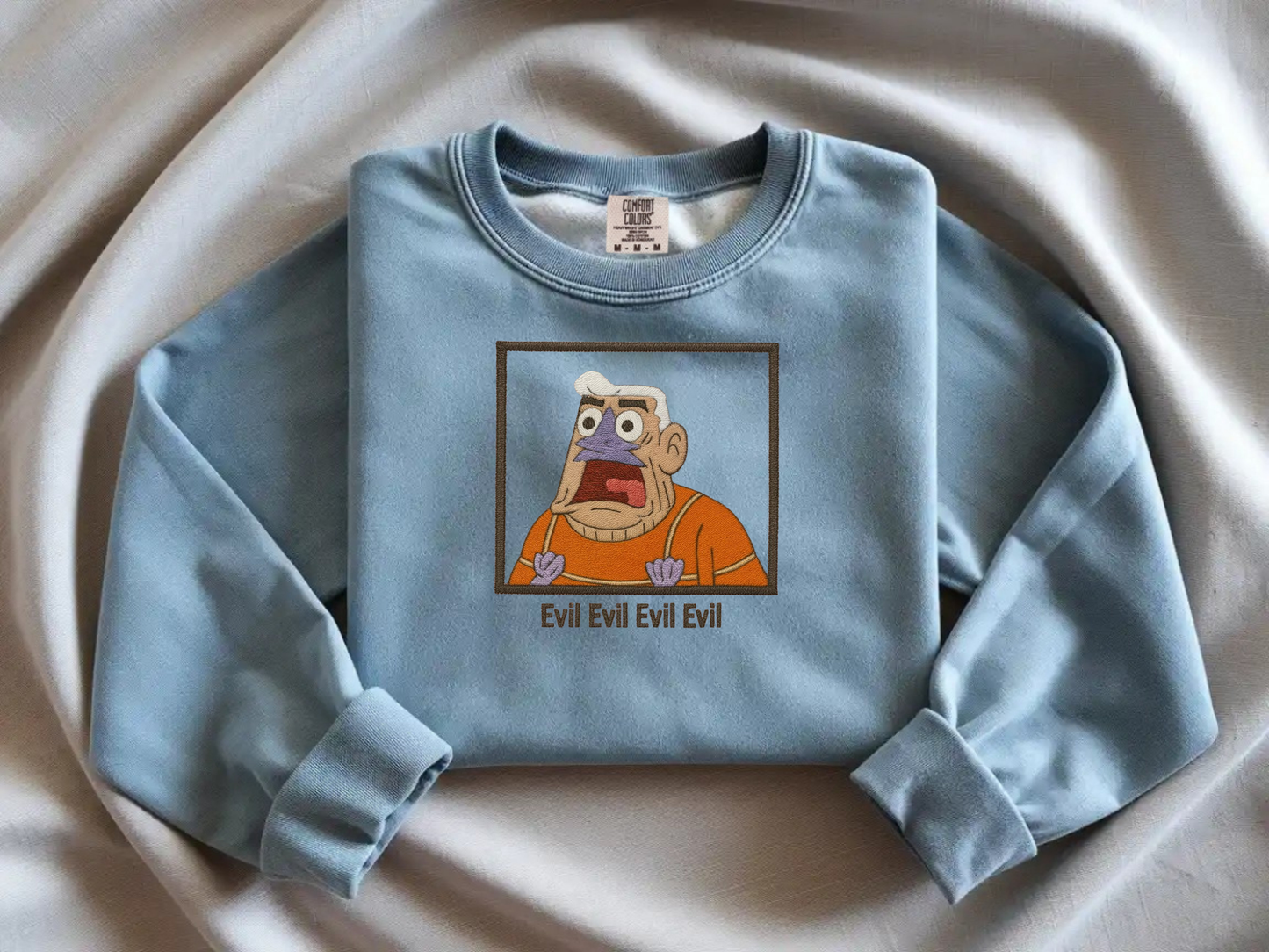 Mermaid Man Evil quote embroidered Blue Jean sweatshirt on Comfort Colors crewneck. Funny SpongeBob nostalgia merch featuring Mermaid Man shouting.