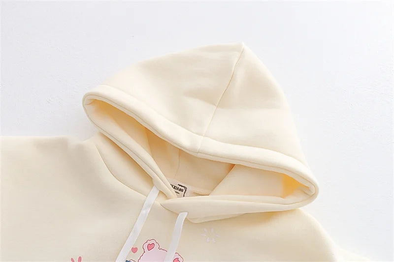 Beige hoodie with a tag on a light gray background