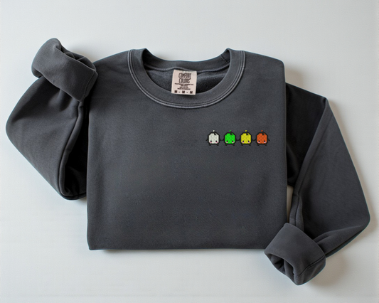 A gray sweatshirt from Comfort Colors with an embroidered design of the Forest Spirits from Stardew Valley.
