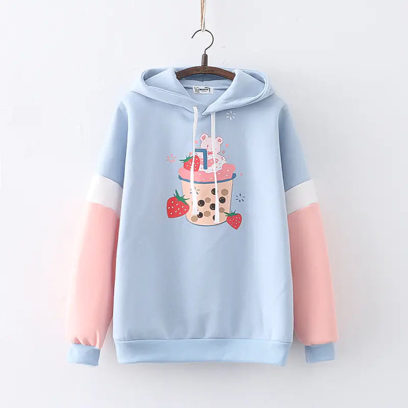Light blue and pink hoodie with a cartoon design on a white background