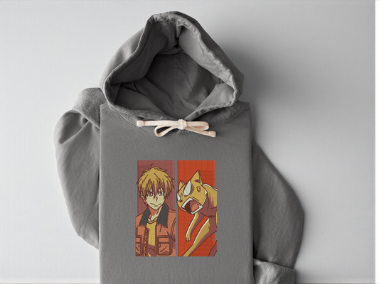 Extreme close-up of high-density embroidery featuring Kyo Sohma from Fruits Basket and his orange cat form on a Grey garment-dyed Comfort Colors 1467 hoodie.