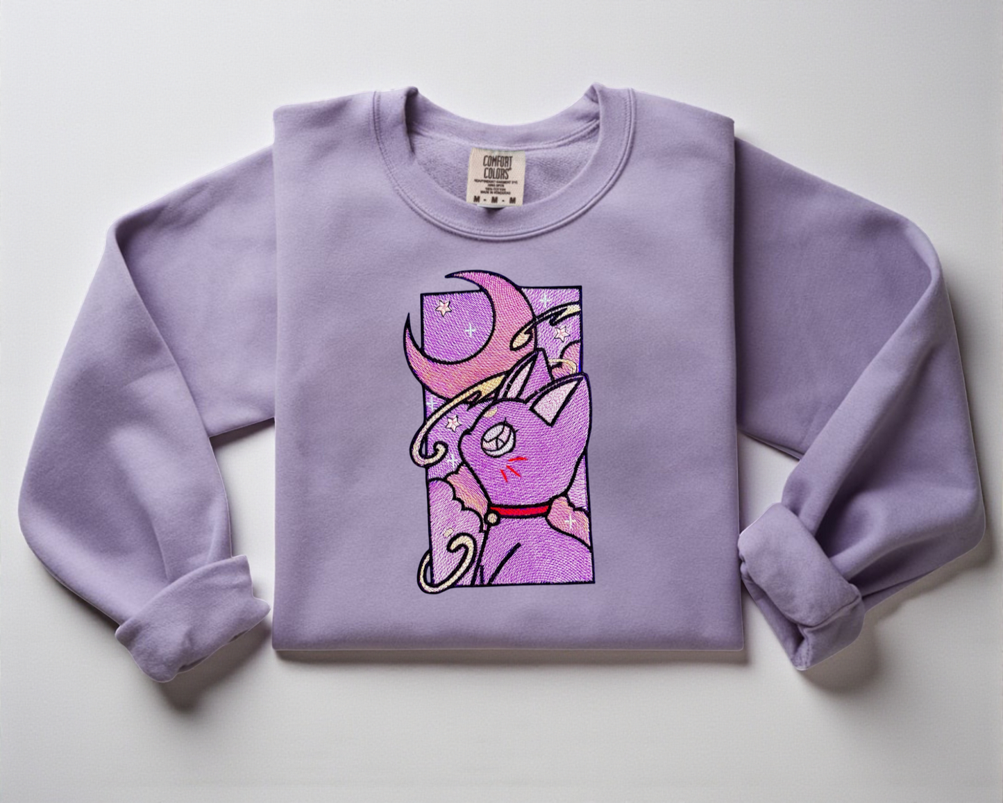 Sailor Moon Cat with moon embroidered on an Orchid Comfort Colors Crewneck sweatshirt.