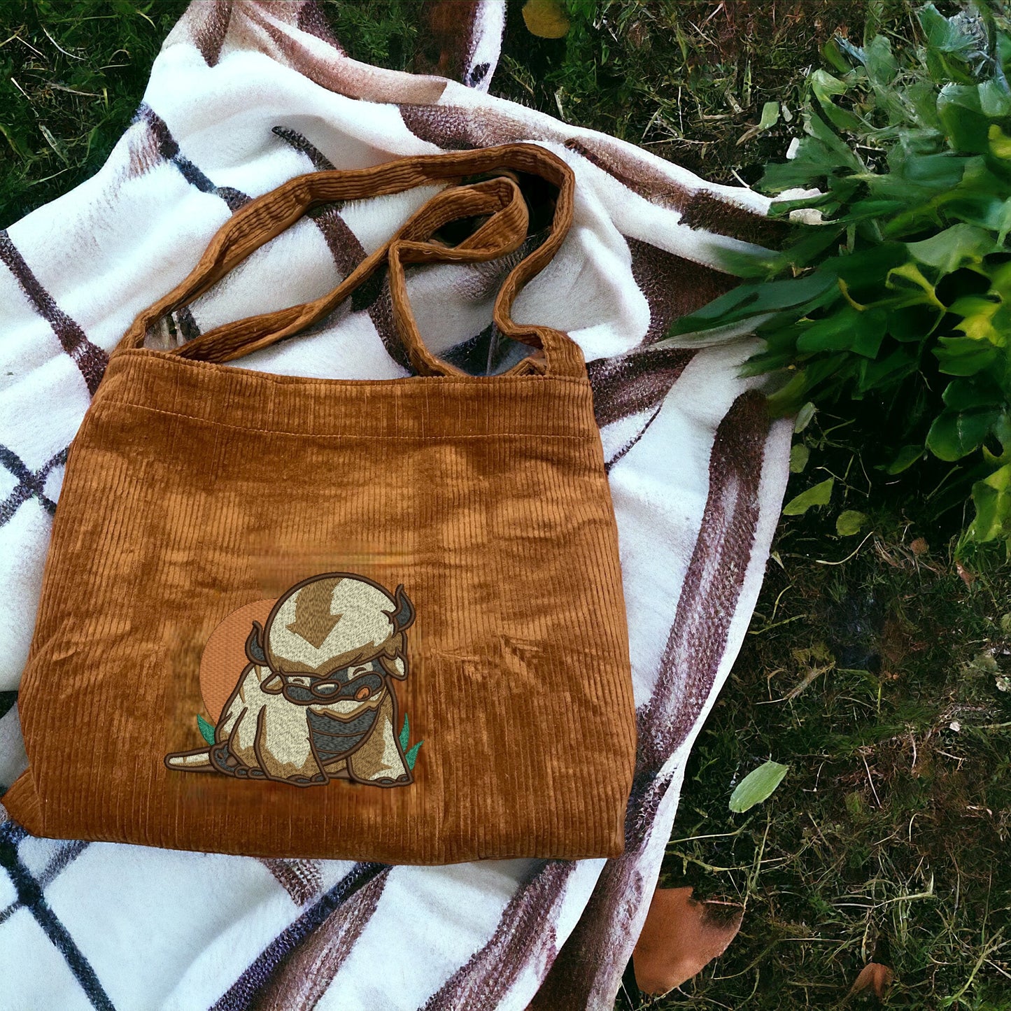Appa from Avatar on n embroidered brown tote bag.