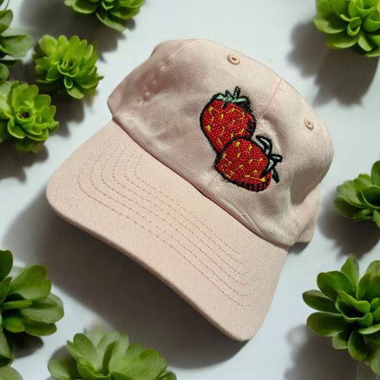An Embroidered hat with a strawberry design