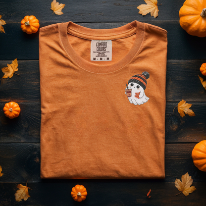 Orange t-shirt with a ghost design and pumpkins on a wooden surface