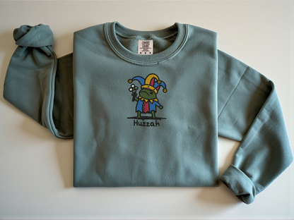Blue Jean vintage navy sweatshirt featuring embroidered Jester Frog shouting Huzzah. Medieval fantasy aesthetic streetwear by Peachnook.