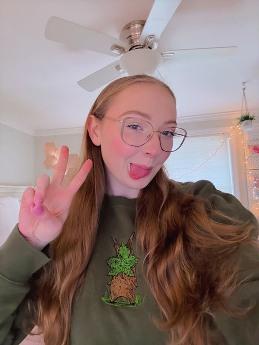 A person with glasses wearing A Korok Green Embroidered Sweatshirt 