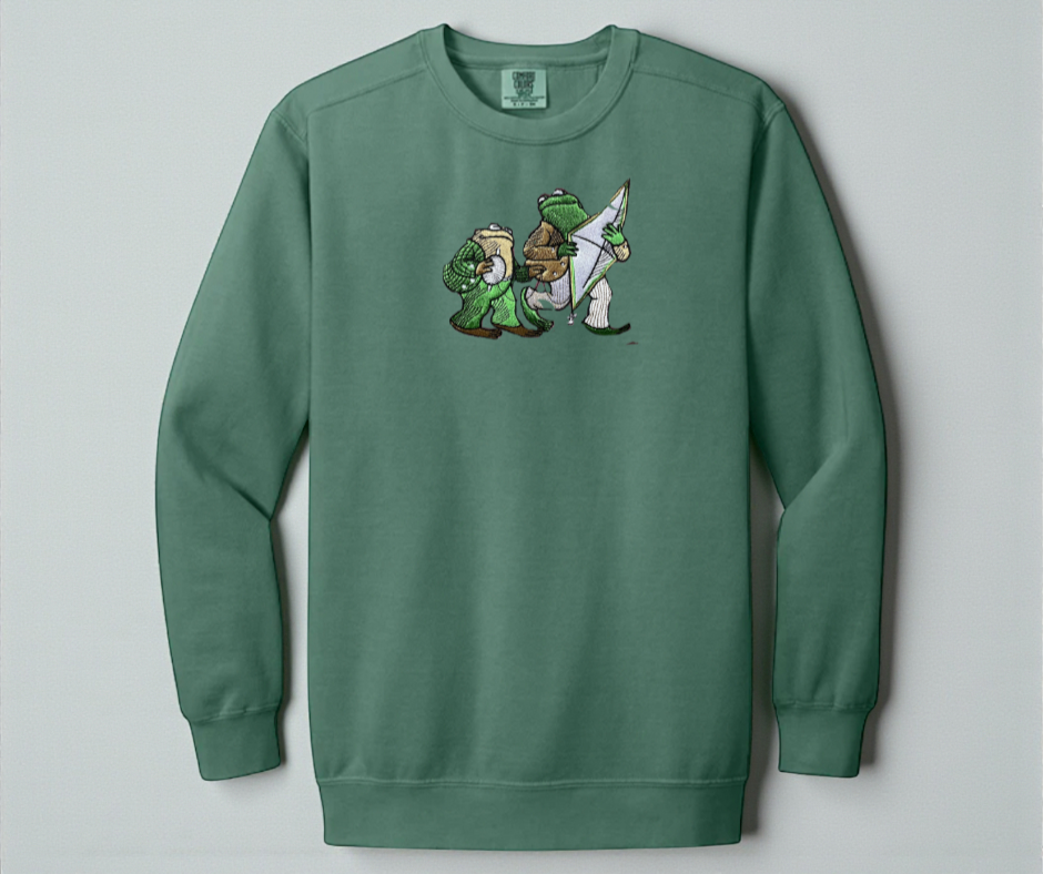 Light Green White Comfort Colors 1566 sweatshirt featuring detailed embroidery of Frog and Toad with a kite. Vintage bookish aesthetic crewneck.