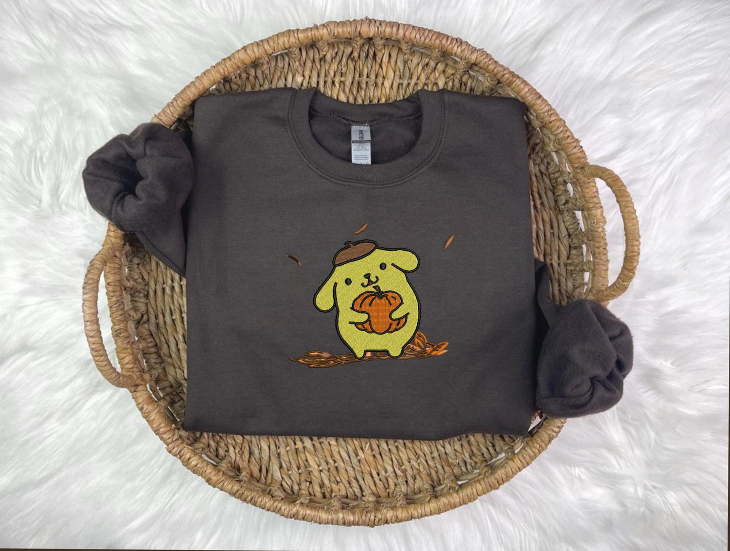 A black sweatshirt with a cartoon animal character embroidered on the front named PomPom