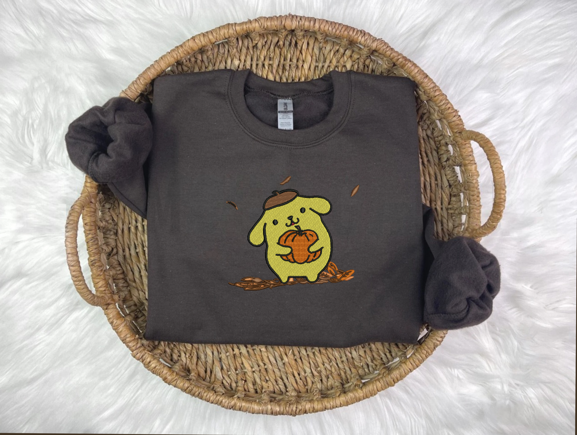 A black sweatshirt with a cartoon animal character embroidered on the front named PomPom