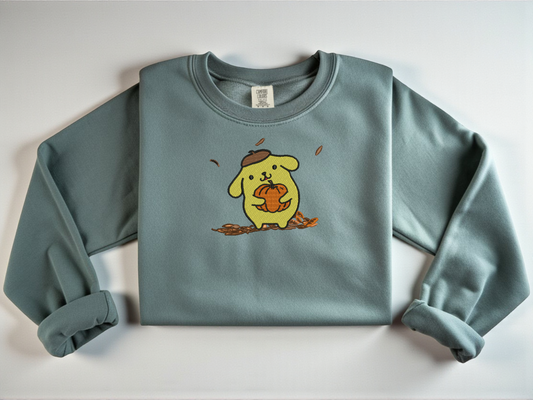 Comfort Colors Blue Spruce with an embroidered Pompompurin holding a pumpkin.