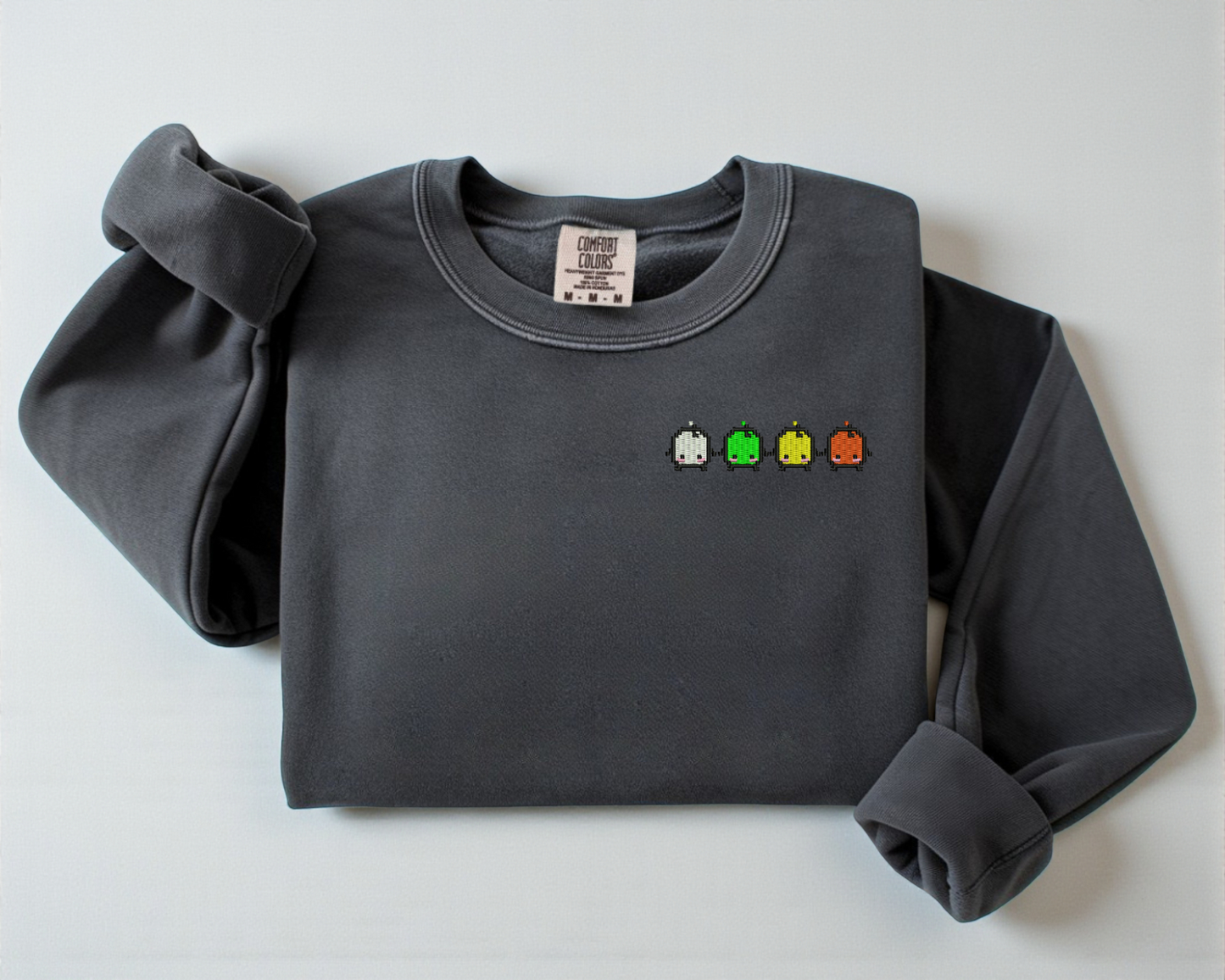 A gray sweatshirt from Comfort Colors with an embroidered design of the Forest Spirits from Stardew Valley.