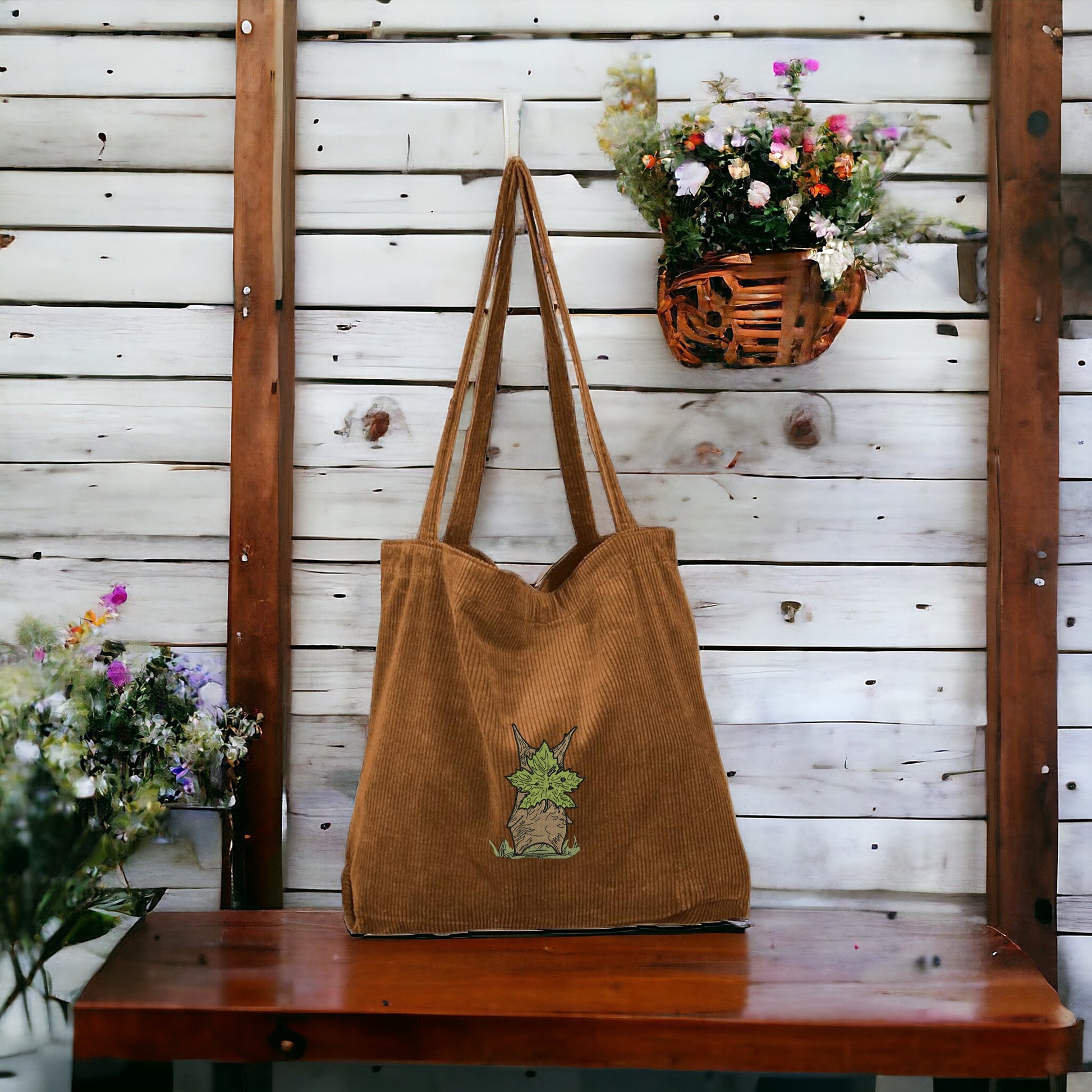 A brown embroidered Tote Bag featuring Korok from Zelda
