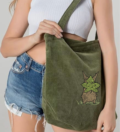A Woman carrying a Zelda Korok Green Embroidered Tote Bag 
