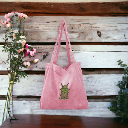 A Pink Embroidered Tote Bag featuring Korok from Zelda
