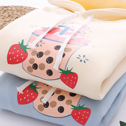 sweatshirts with strawberry and bubble tea design on a light background