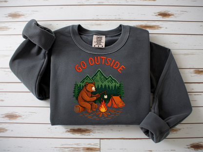 Camping bear embroidered pepper crew neck sweatshirt featuring a bear roasting marshmallows by a campfire, cozy outdoor apparel for nature lovers.