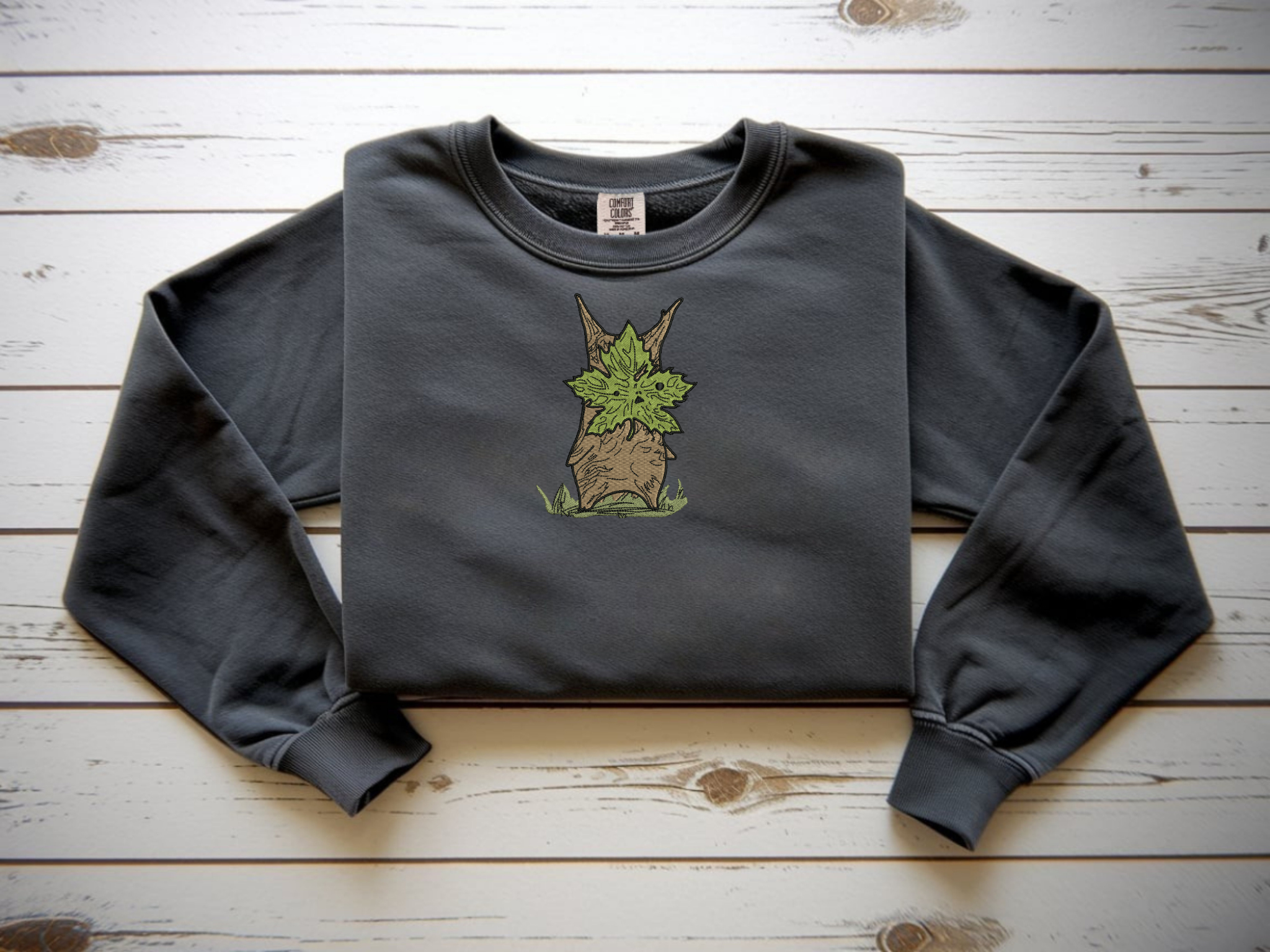  Close-up of embroidery showing a wooden Korok with a green leaf mask.