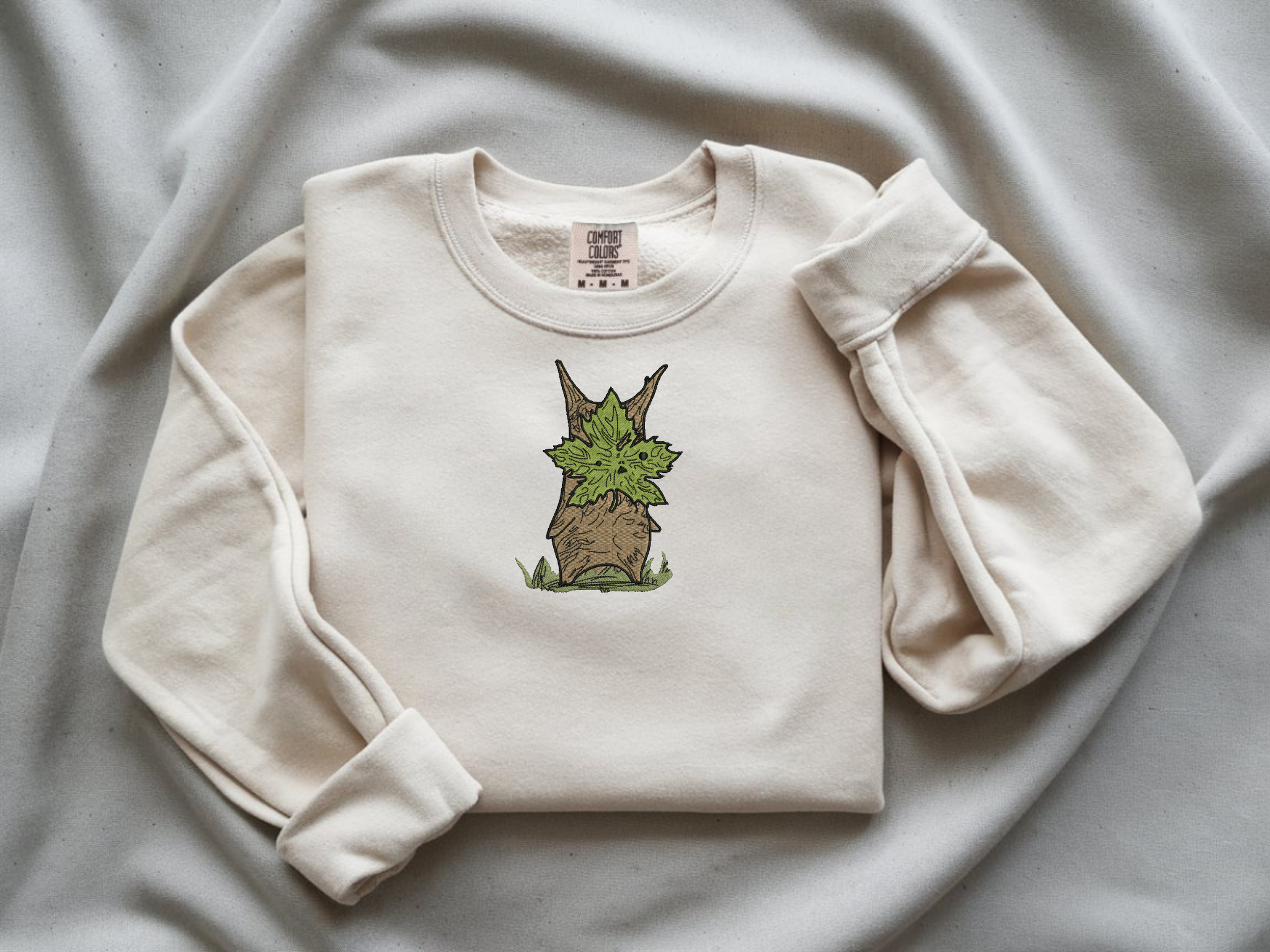  Embroidered Korok forest spirit on a white Comfort Colors 1566 sweatshirt.