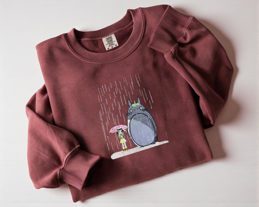 Crimson crew neck sweatshirt featuring an embroidered My Neighbor Totoro design, cute Japanese anime apparel for Ghibli fans.